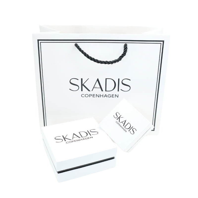 White Jewelry handbag and jewelry box with SKADIS Jewelry logo in a white background.