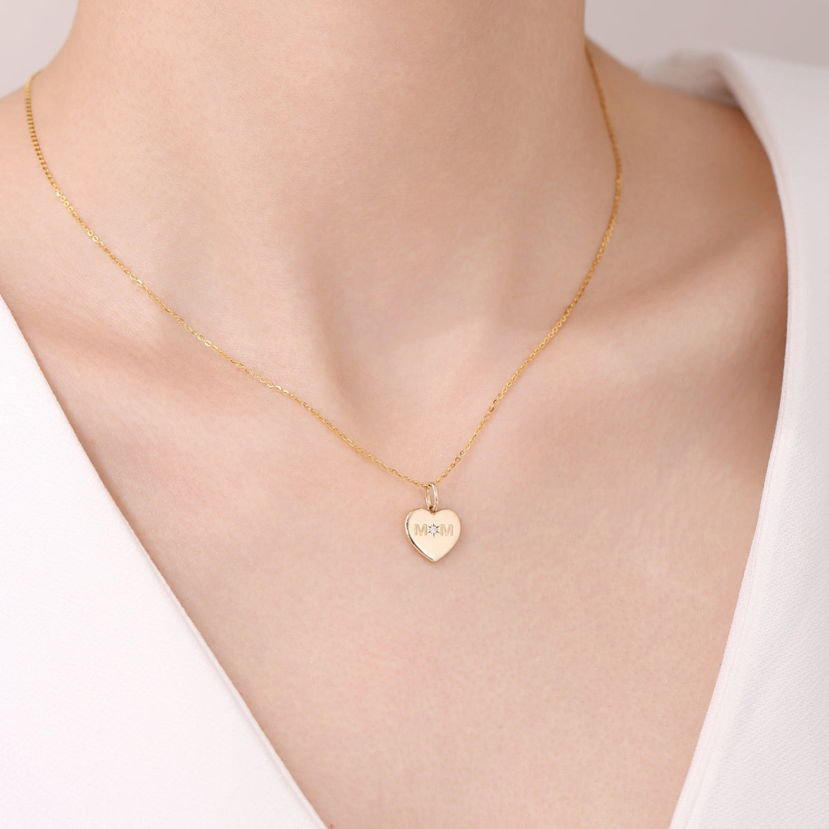 Gold necklace with a heart-shaped pendant from SKADIS Jewelry