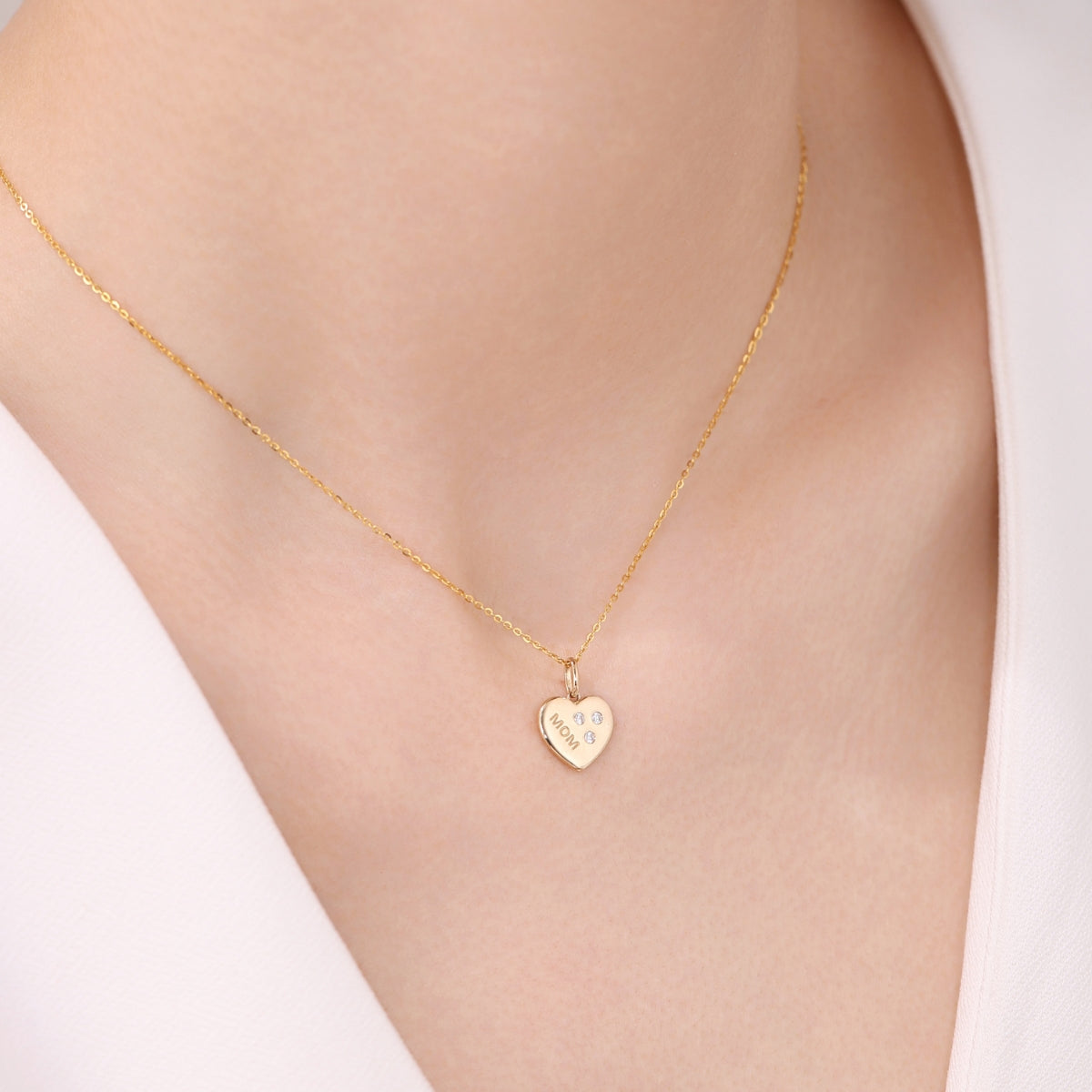Gold necklace with a heart-shaped pendant from SKADIS Jewelry