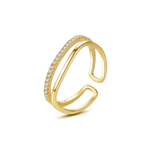 Gold open ring with embedded zirconia on a white background
