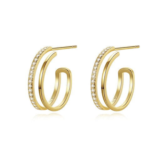 Gold hoop earrings with zirconian on a white background.