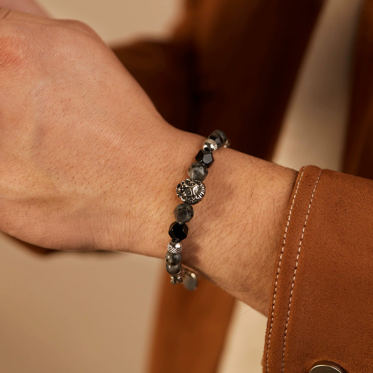 Close-up of a wrist wearing a black beaded bracelet from SKADIS jEWELRY