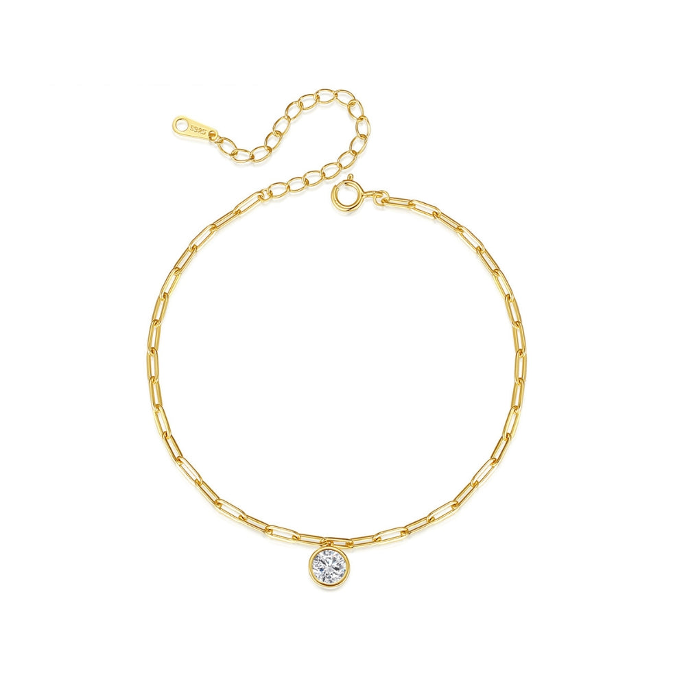 Gold chain bracelet with a small round zirconia on a white background
