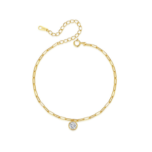 Gold chain bracelet with a small round zirconia on a white background