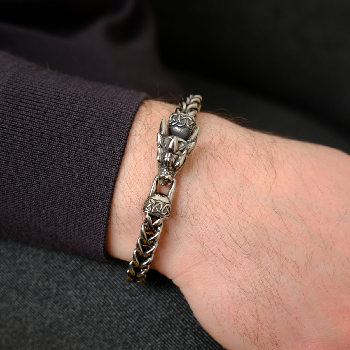 Men's bracelet with dragon design on a wrist from SKADIS Jewelry