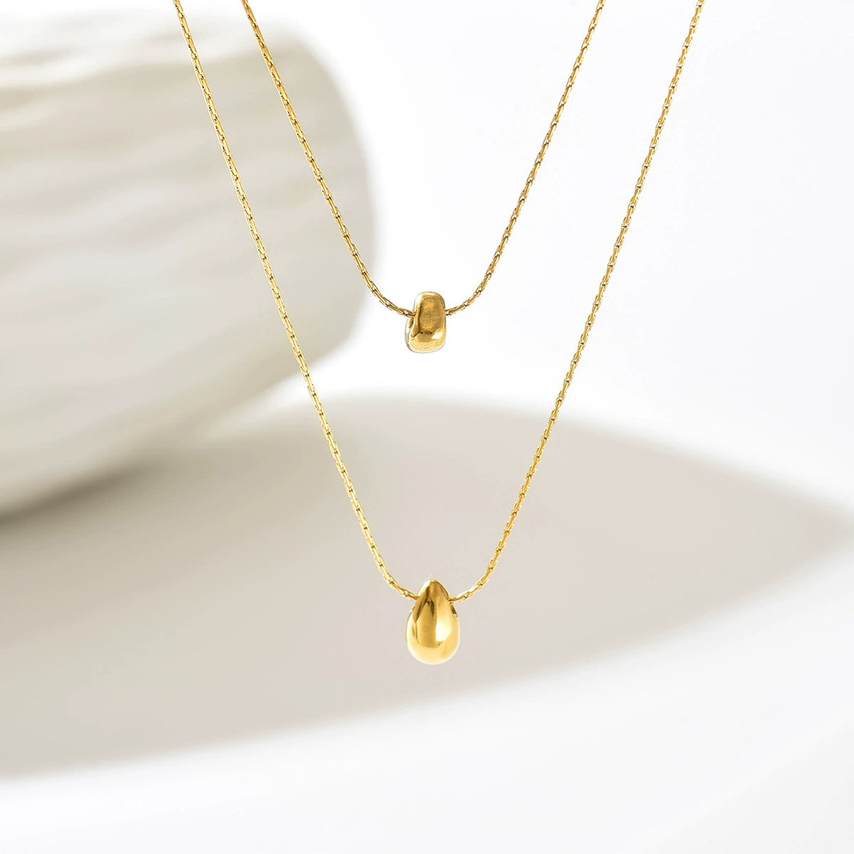 Gold necklace with a teardrop-shaped pendant from SKADIS Jewelry