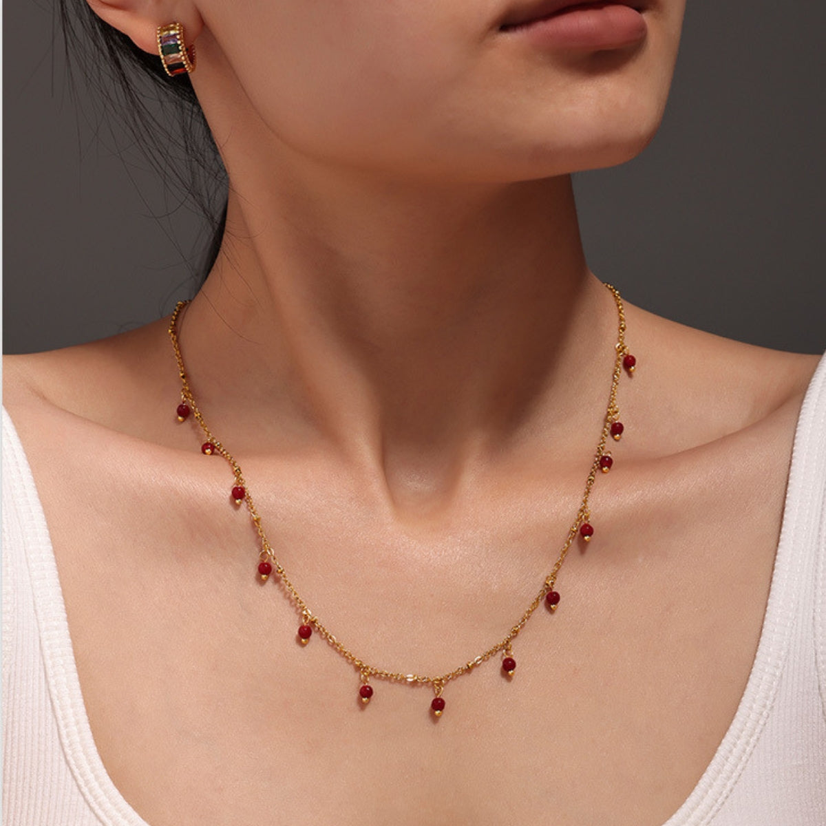 Necklace with red beads worn by a person   - SKADIS Jewelry
