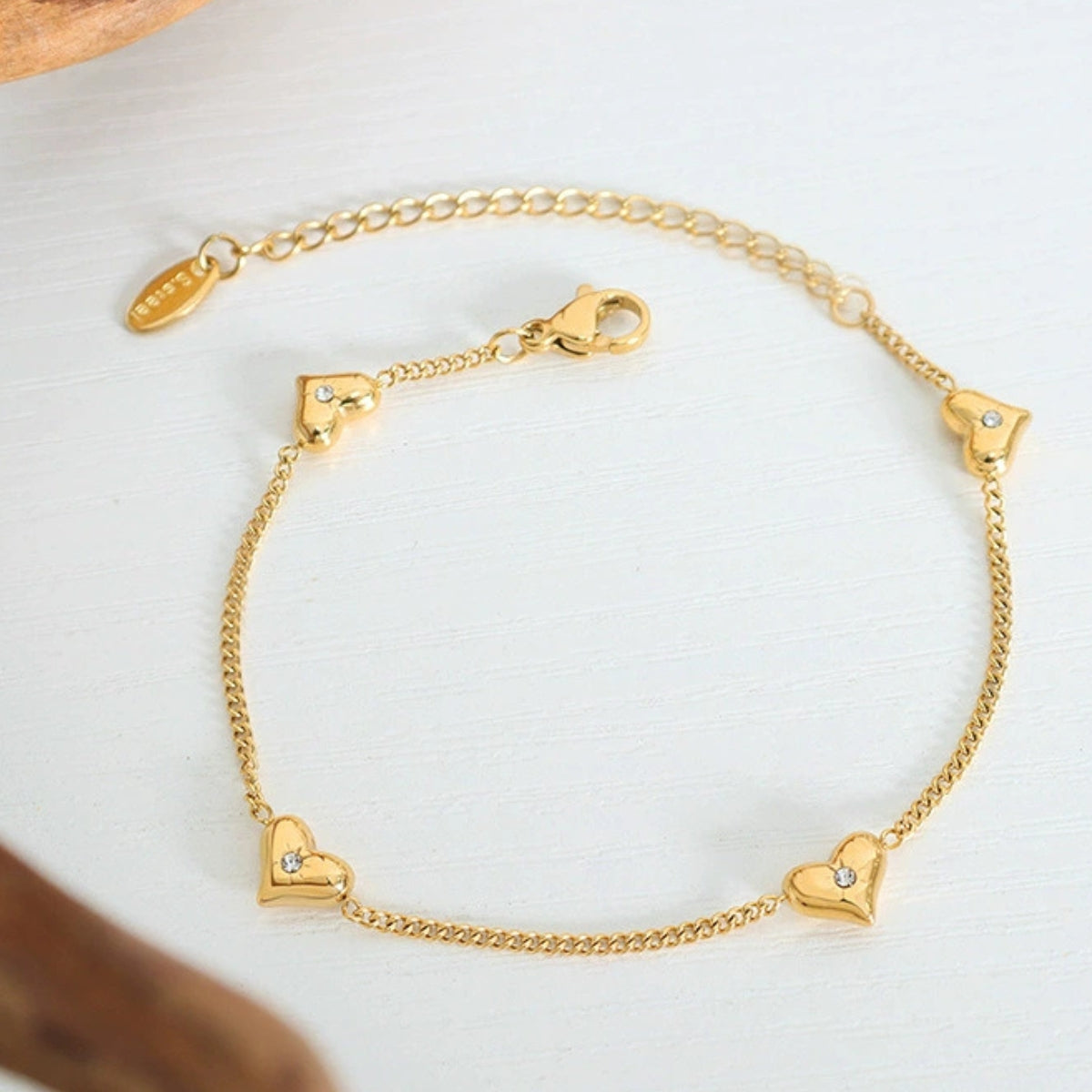 Gold bracelet with heart-shaped charms from SKADIS Jewelry