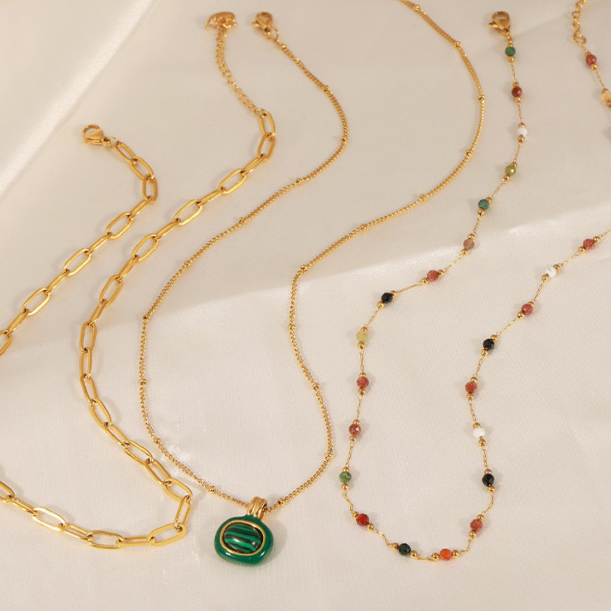 Three gold necklaces with different designs from SKADIS Jewelry