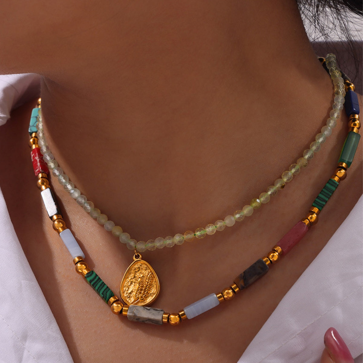 Colorful beaded necklace with a gold pendant on a person's neck - SKADIS Jewelry