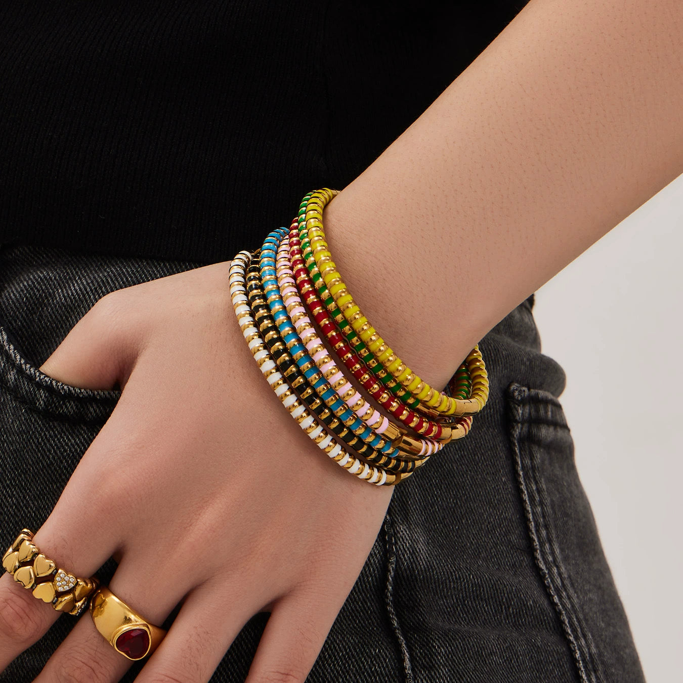 Hand wearing colorful enamel from SKADIS Jewelry