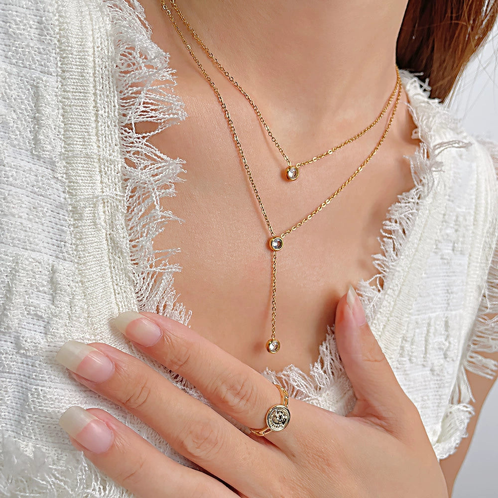 Gold necklace and ring on a person from SKADIS Jewelry