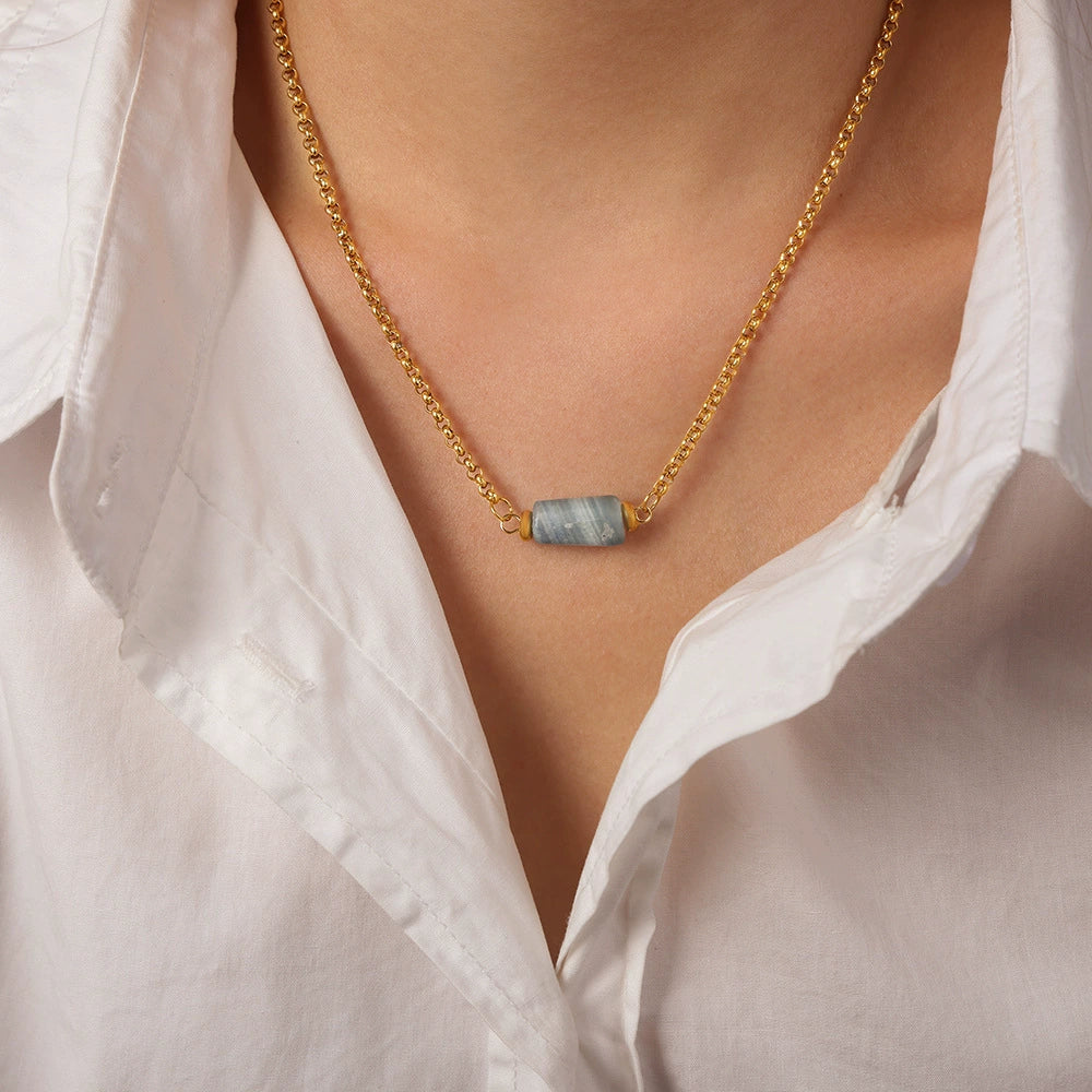 Gold necklace with a blue pendant from SKADIS Jewelry