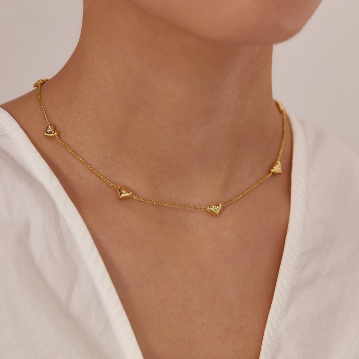 Gold necklace with heart pendants from SKADIS Jewelry