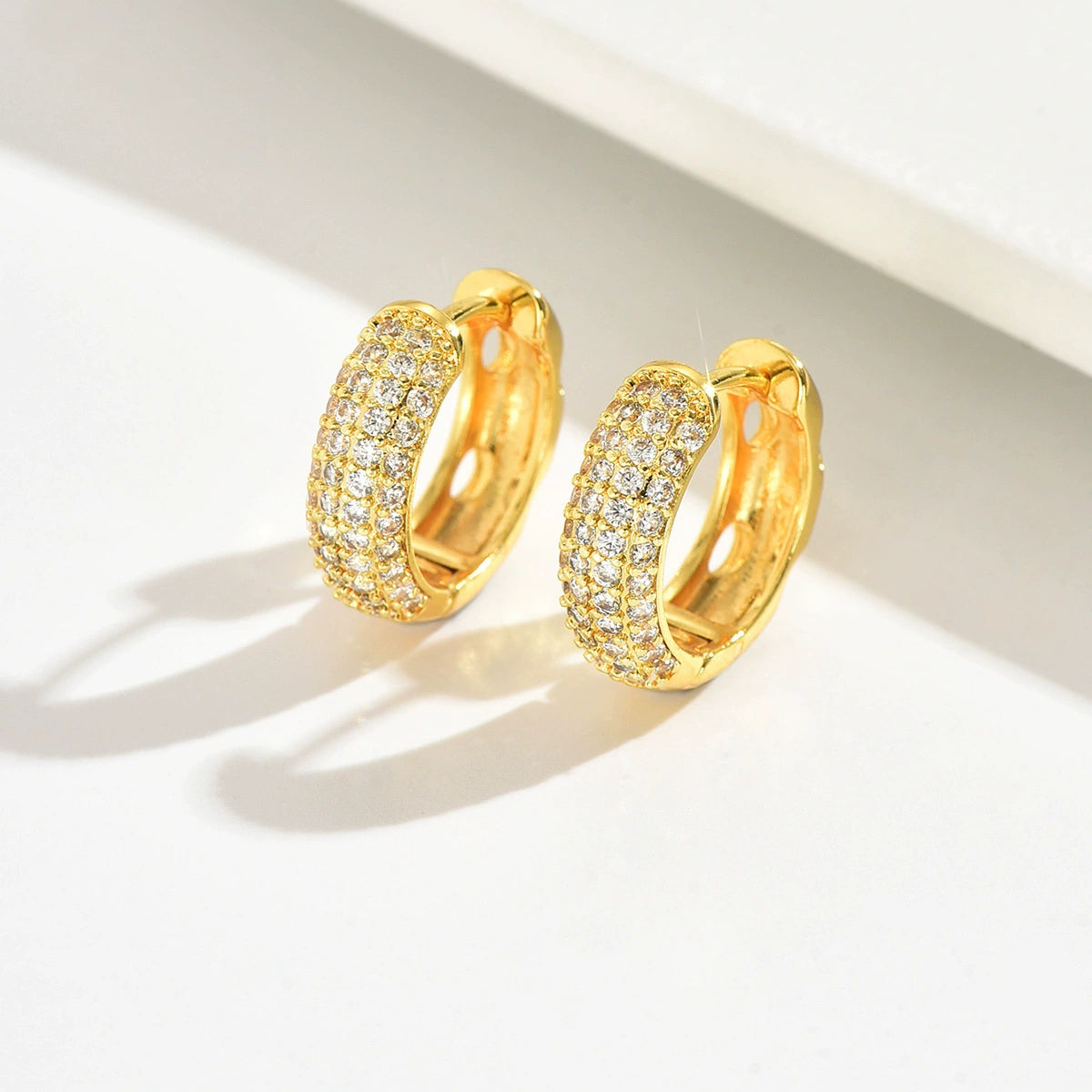 Gold hoop earrings with zirconia from SKADIS Jewelry