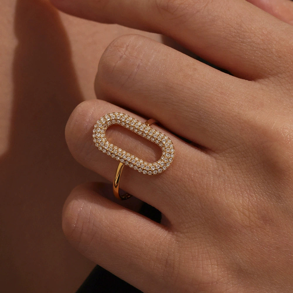 Gold ring with zirconia accents on a hand against SKADIS Jewelry