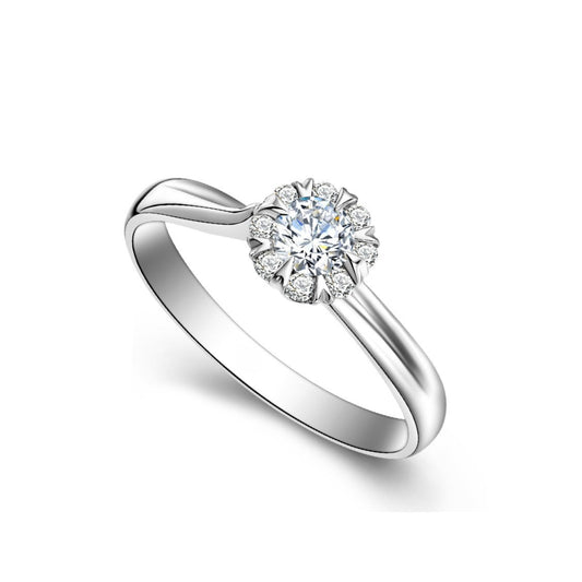 A 18k white gold diamond ring heart shape prongs with a central diamond surrounded by smaller diamonds.