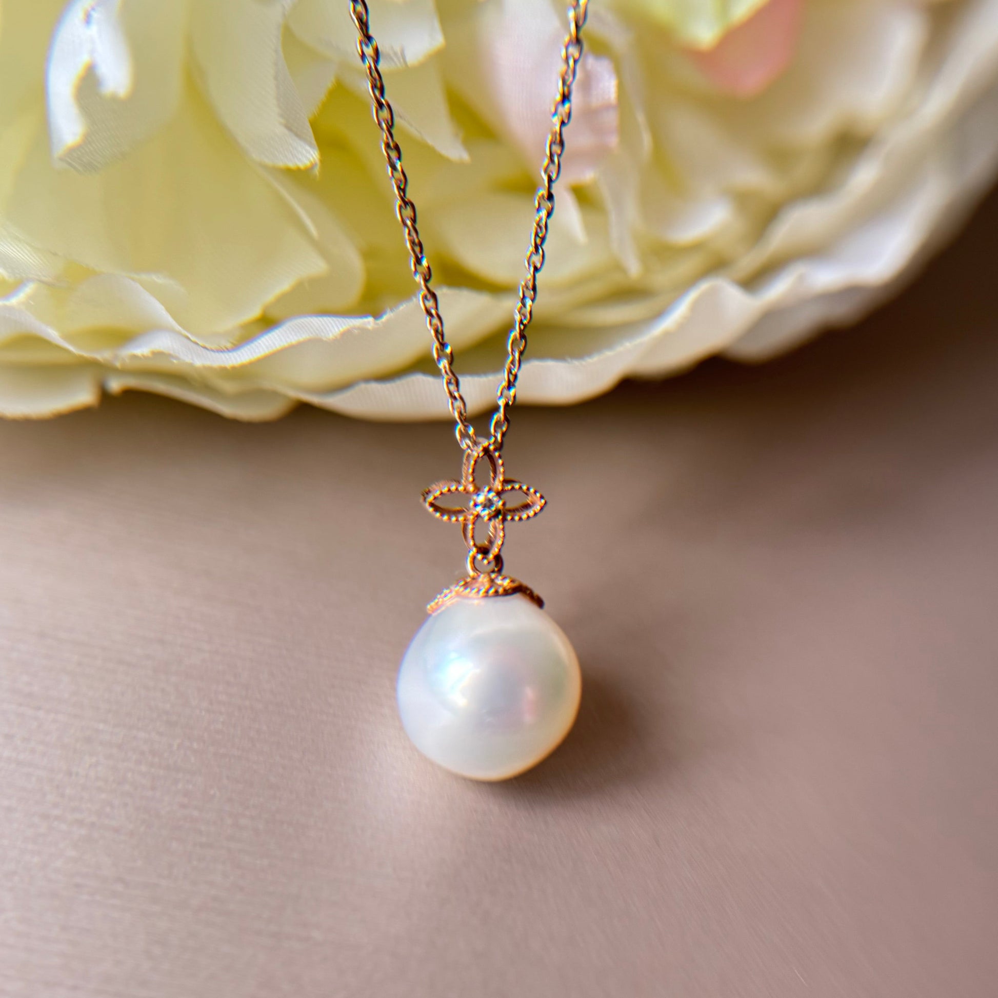 South sea pearl  pendant with a gold chain on a soft background.