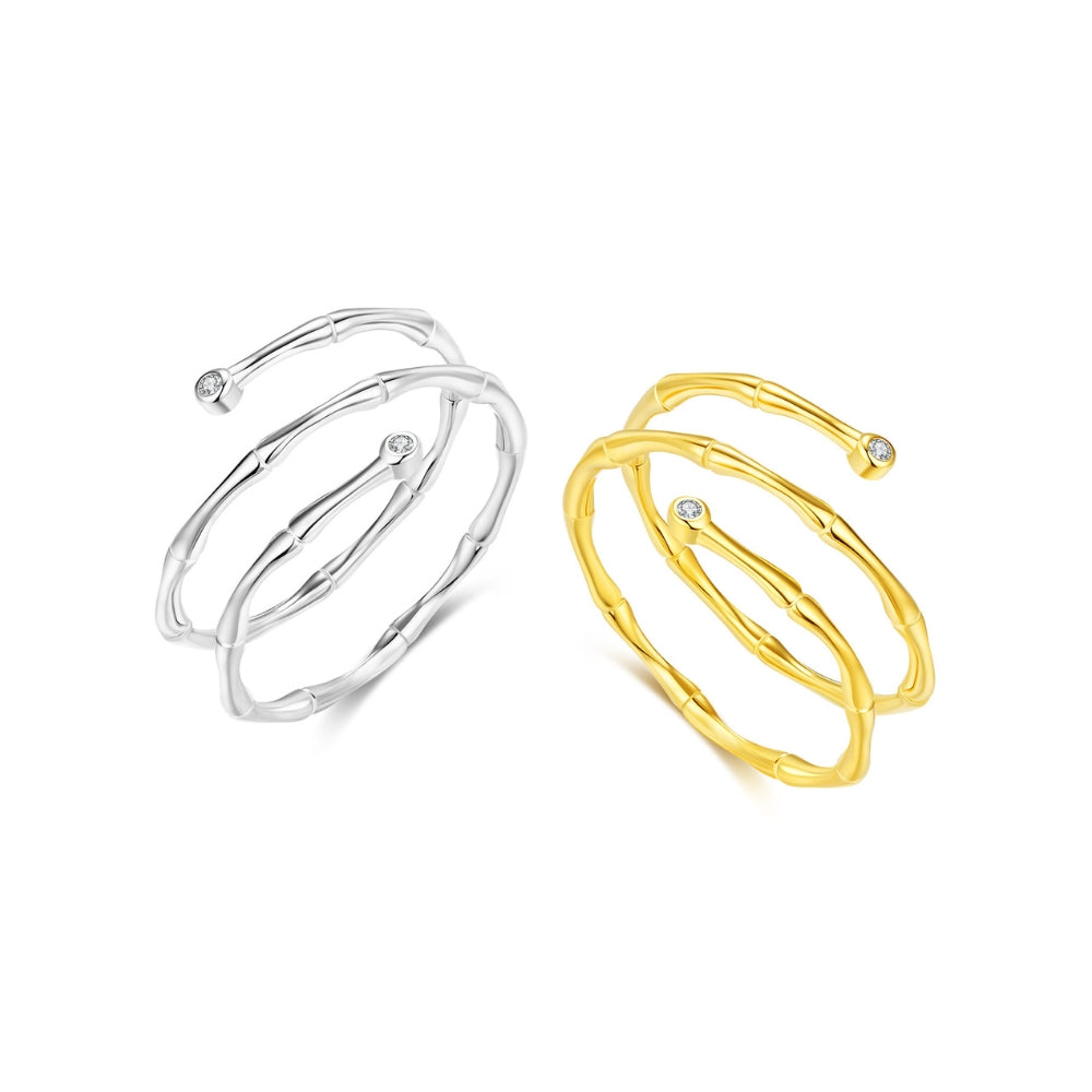 Two gold and silver bangles on a white background