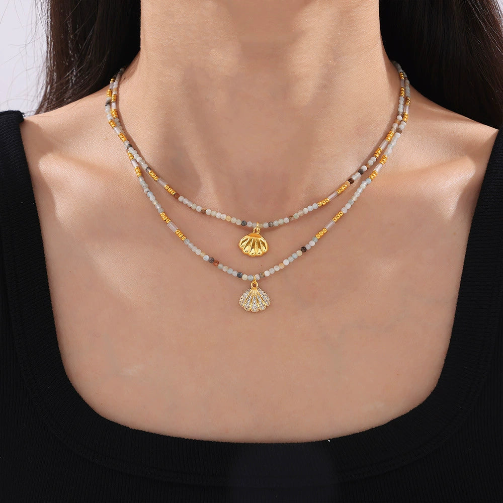 Necklace with shell pendants on a person from SKADIS Jewelry