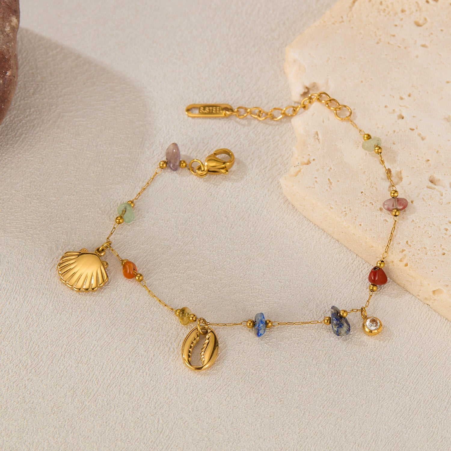 Gold bracelet with shell and bead charms from SKADIS Jewelry