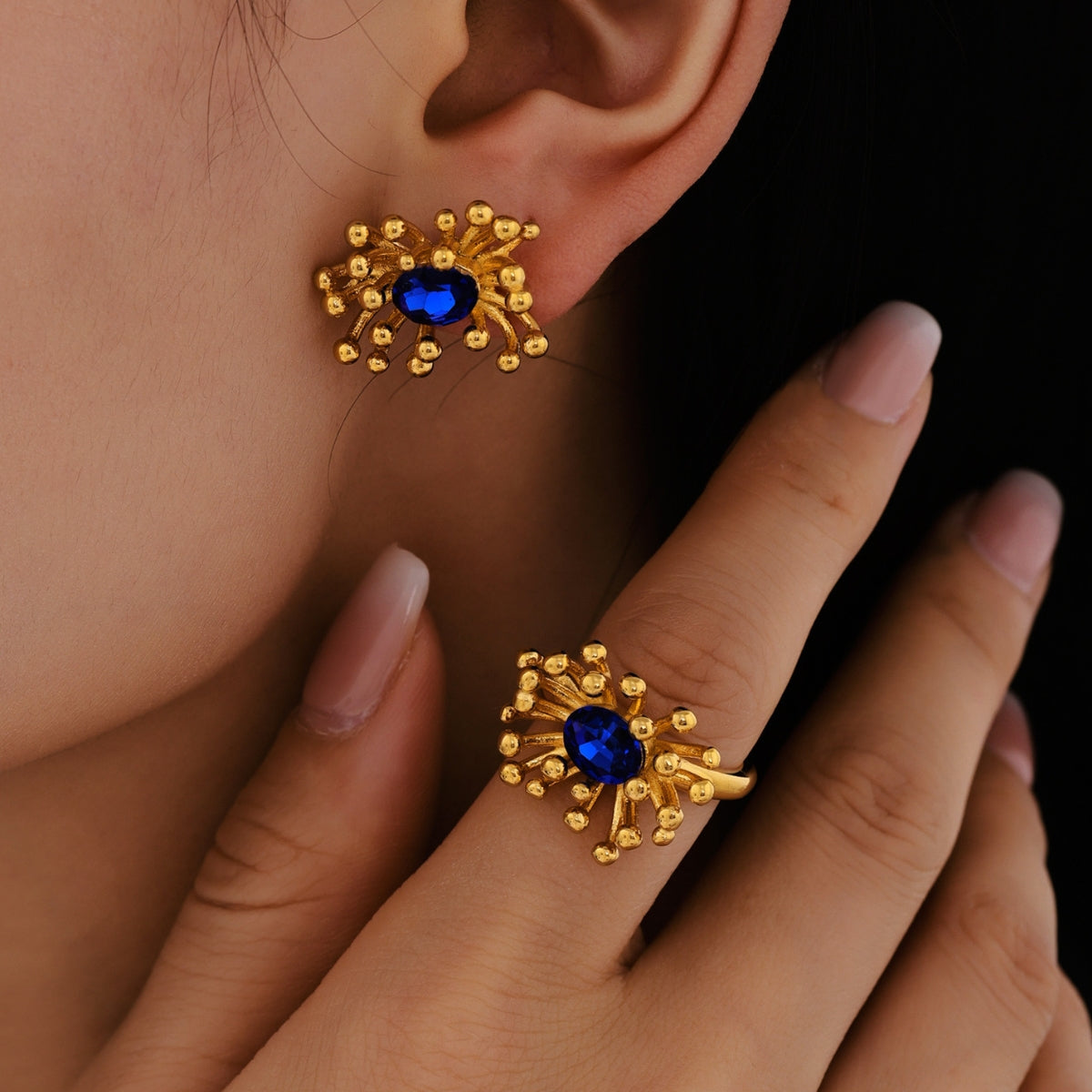 Gold earrings with blue stones from SKADIS Jewelry