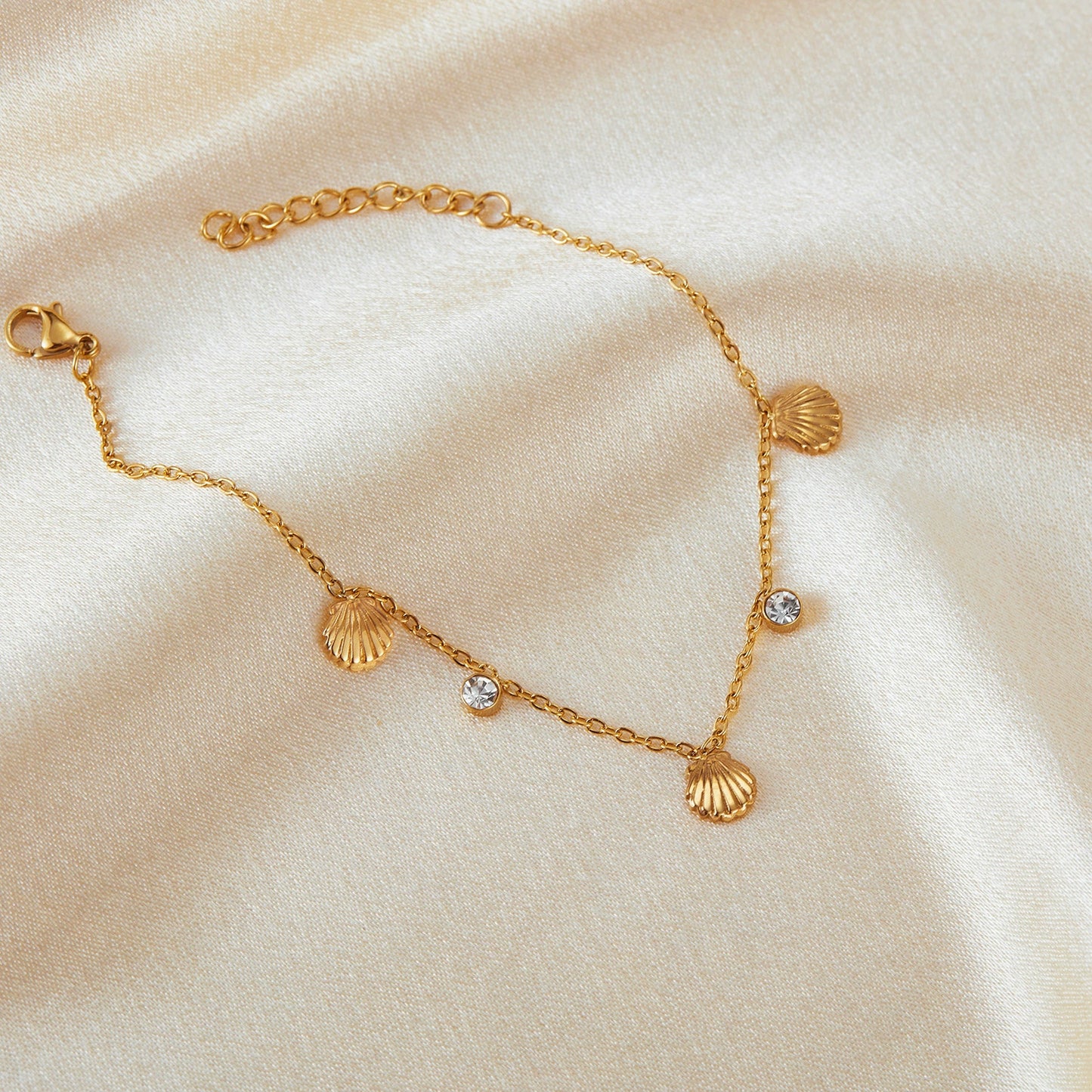 Gold bracelet with shell and zirconia charms from SKADIS Jewelry