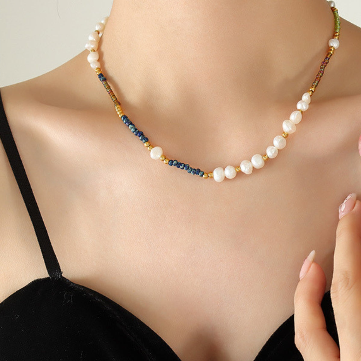 Pearl necklace with multi colored beads on a person SKADIS Jewelry
