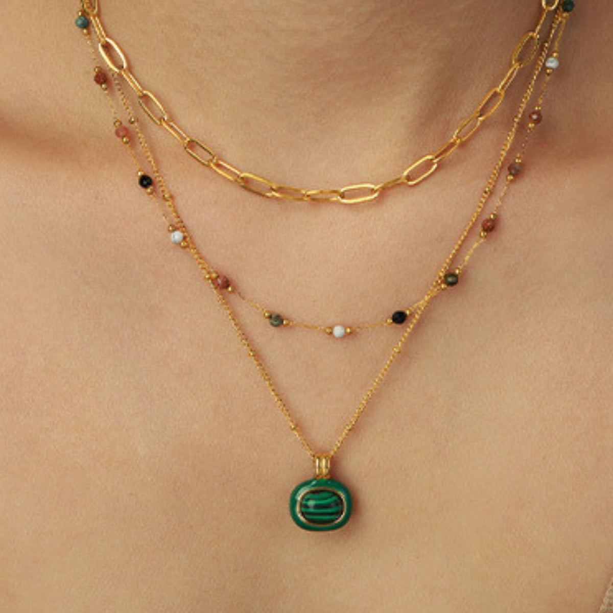 Gold necklaces with colored stones and green pendant from SKADIS Jewelry