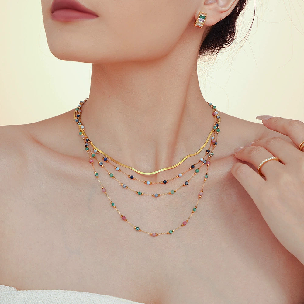 A woman wearing a colorful beaded necklace from SKADIS Jewelry