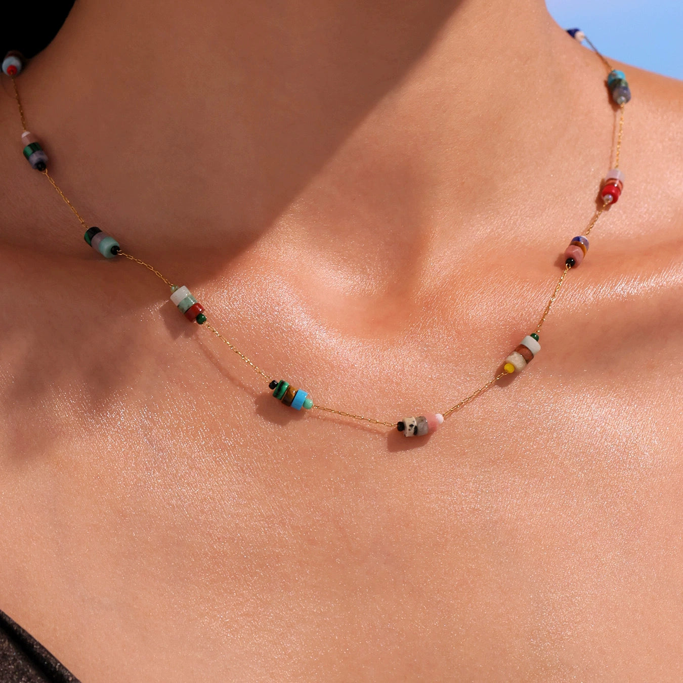 Necklace with colorful beads on a person's neck from SKADIS Jewelry