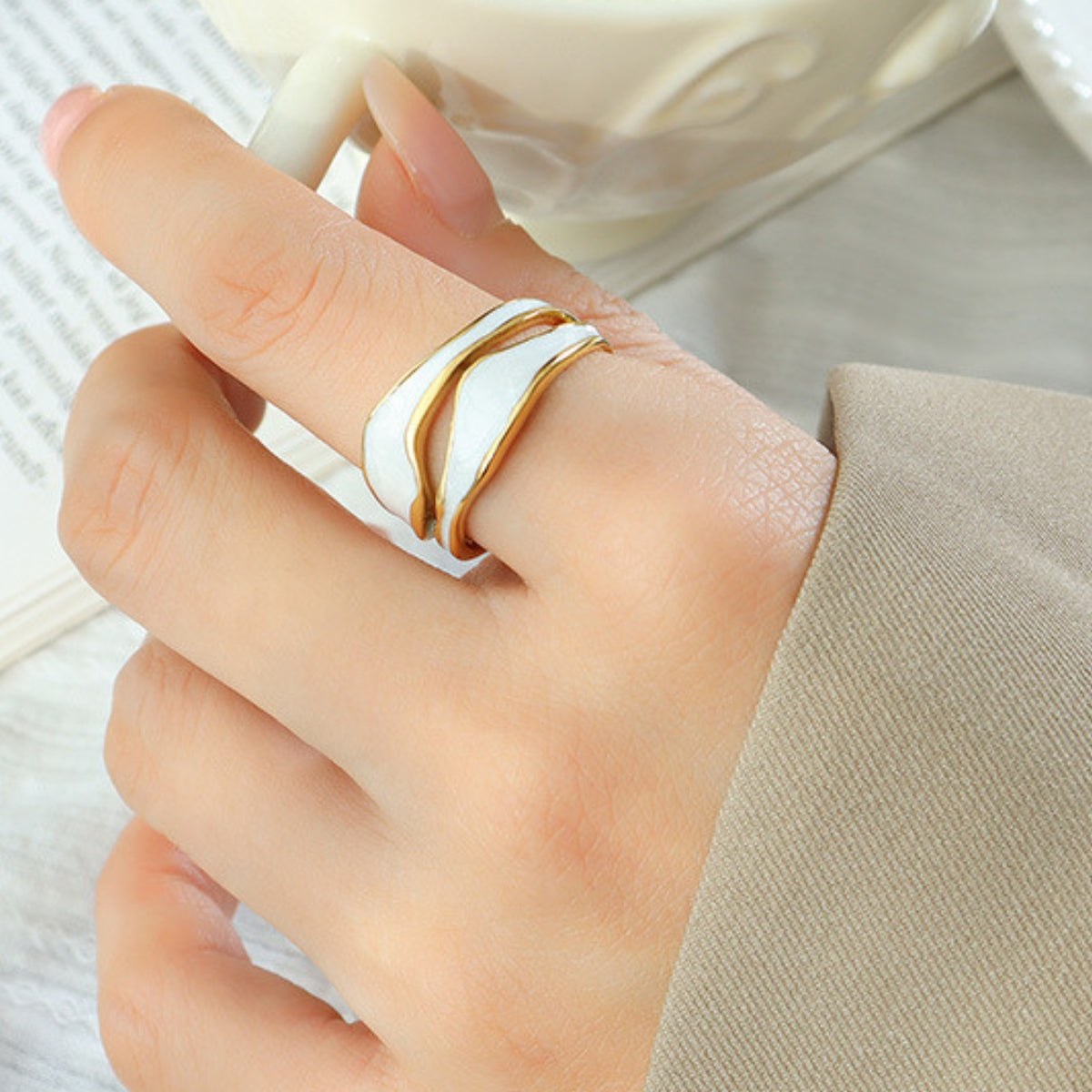 Hand wearing a white ring from SKADIS Jewelry
