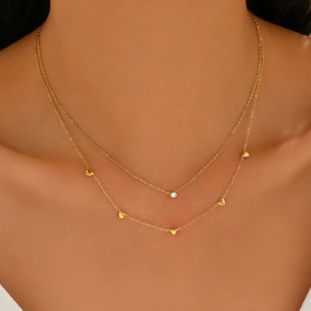 Gold necklace with heart pendants from SKADIS Jewelry