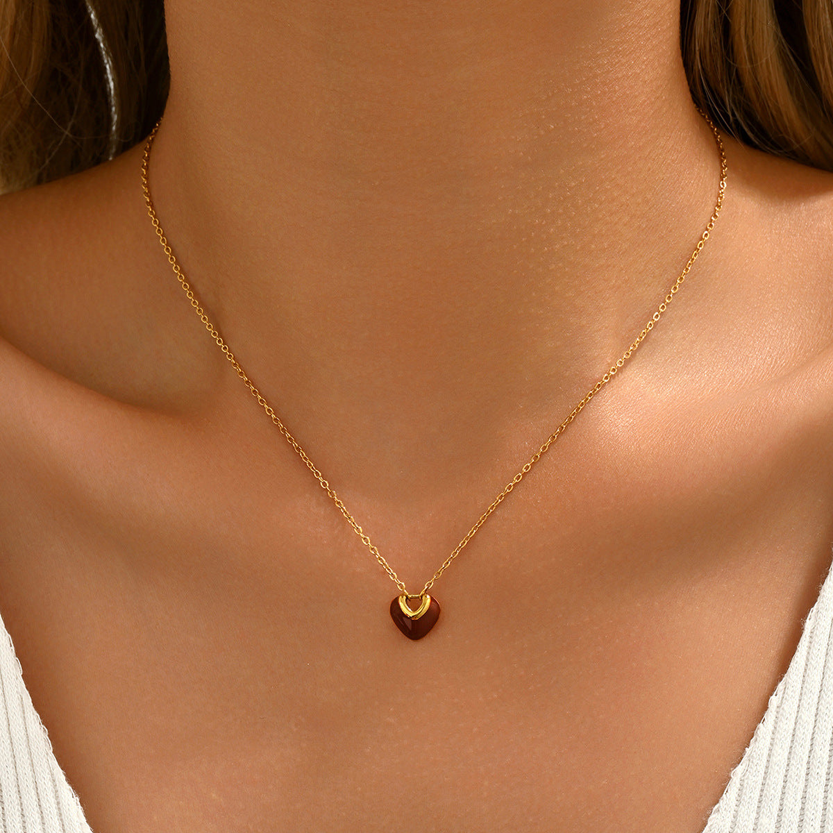 Gold necklace with a red heart pendant from SKADIS Jewelry