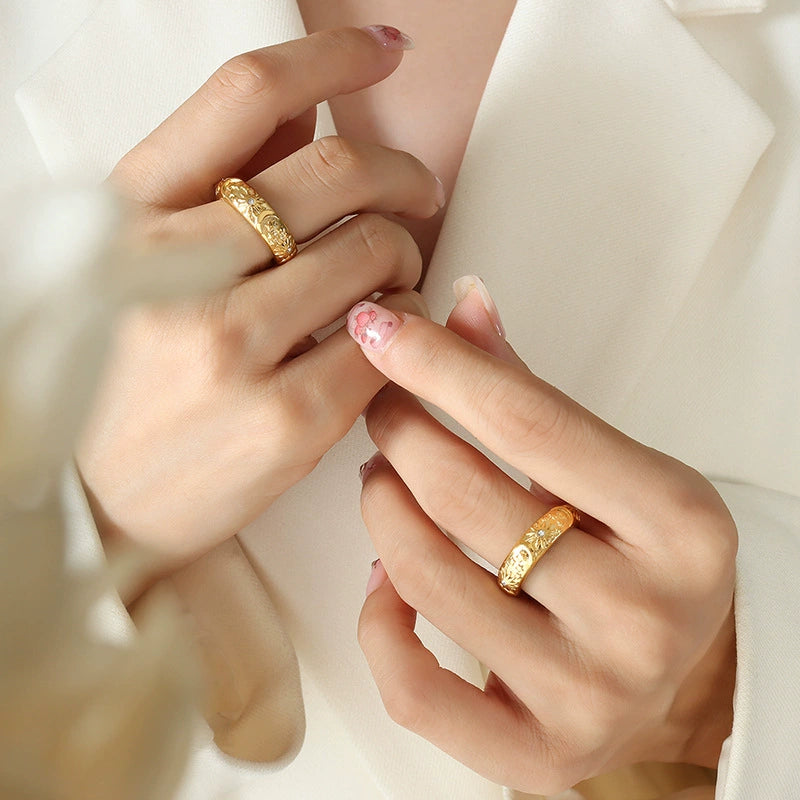 Close-up of hands wearing gold rings with stars from SKADIS Jewelry
